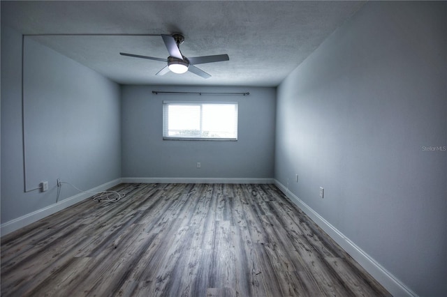 empty room with hardwood / wood-style floors, ceiling fan, and a textured ceiling