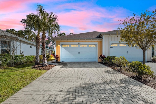 view of front of house featuring a garage and a yard