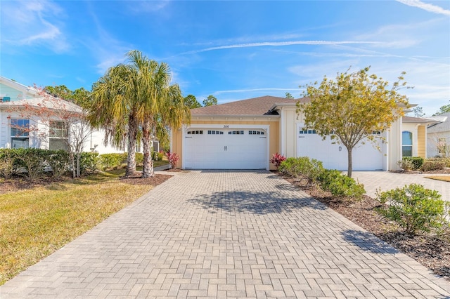 view of front of property with a garage and a front yard