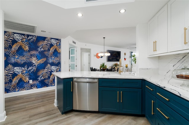 kitchen featuring stainless steel dishwasher, kitchen peninsula, sink, and light hardwood / wood-style flooring