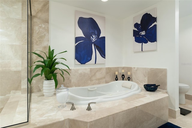 bathroom featuring toilet, a relaxing tiled tub, and tile patterned flooring