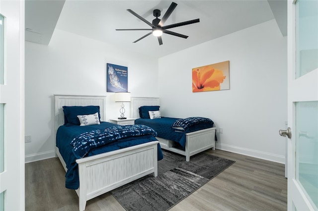 bedroom featuring ceiling fan and dark hardwood / wood-style floors