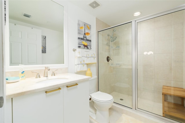 bathroom featuring vanity, toilet, and an enclosed shower