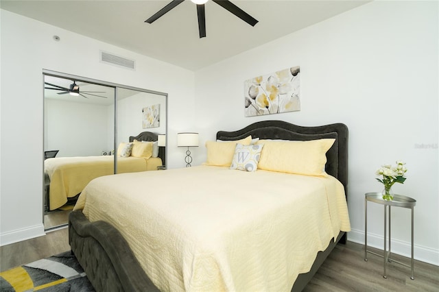 bedroom featuring ceiling fan, a closet, and hardwood / wood-style flooring