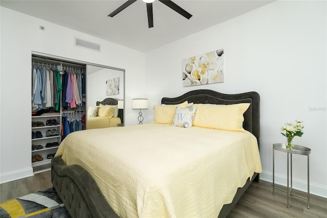 bedroom with ceiling fan, dark hardwood / wood-style floors, and a closet