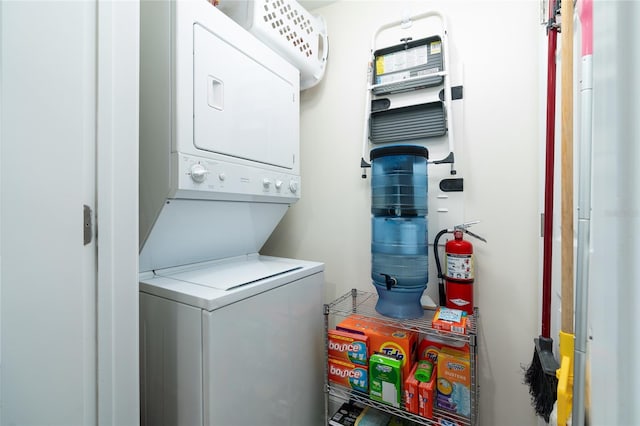 washroom featuring stacked washing maching and dryer