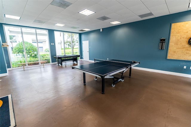 game room featuring pool table, expansive windows, and a drop ceiling