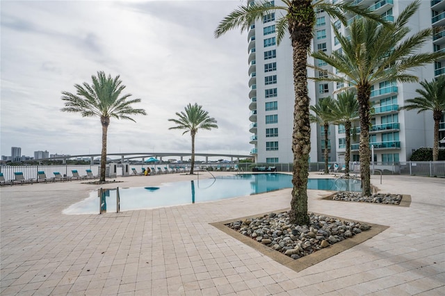 view of swimming pool featuring a water view