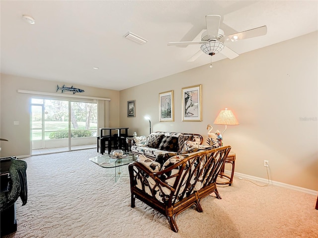 carpeted living room with ceiling fan