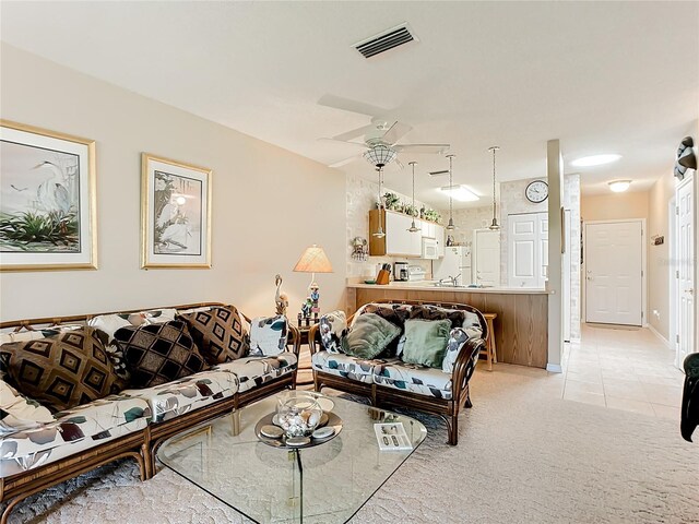 carpeted living room featuring ceiling fan