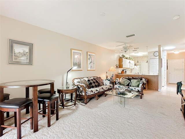 living room with ceiling fan and light colored carpet