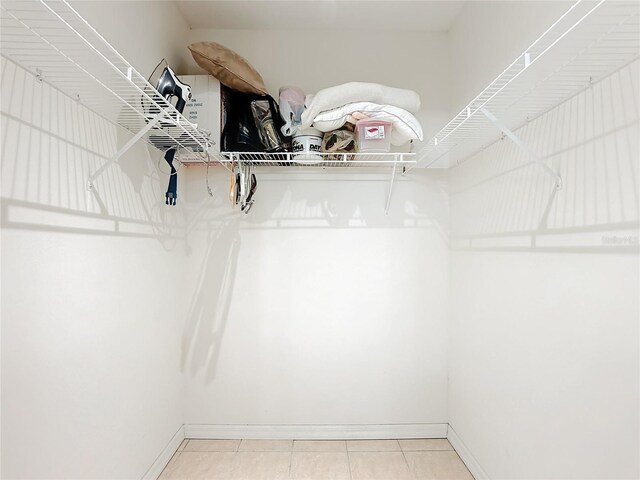 spacious closet featuring light tile patterned flooring