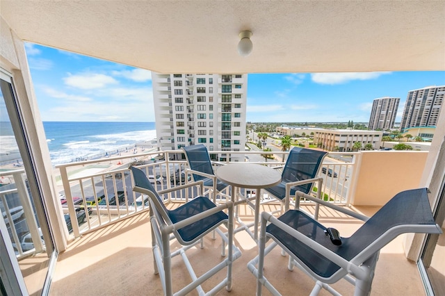 balcony with a view of the beach and a water view