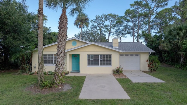 ranch-style home with a garage and a front lawn