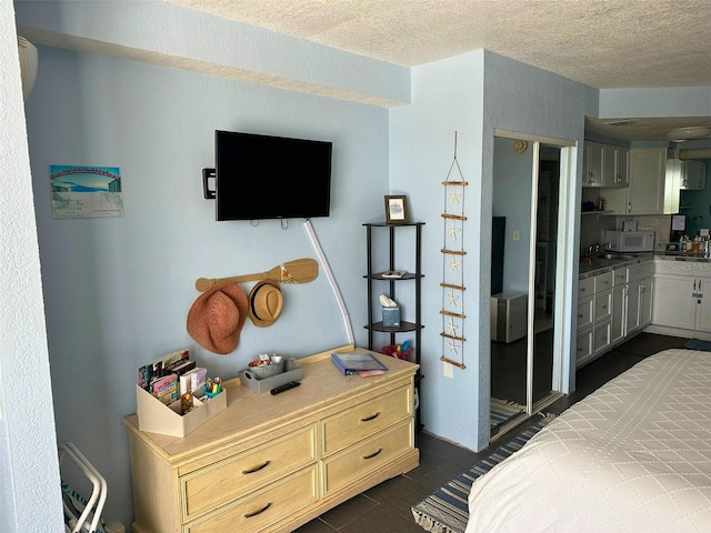 bedroom featuring a textured ceiling and connected bathroom