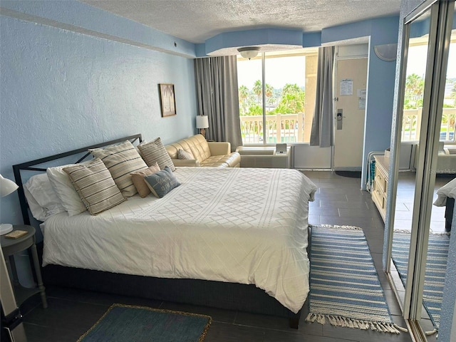 2700 N Atlantic Ave Unit 433, Daytona Beach, FL 32118 - bedroom featuring a textured wall, a textured ceiling, and wood finished floors