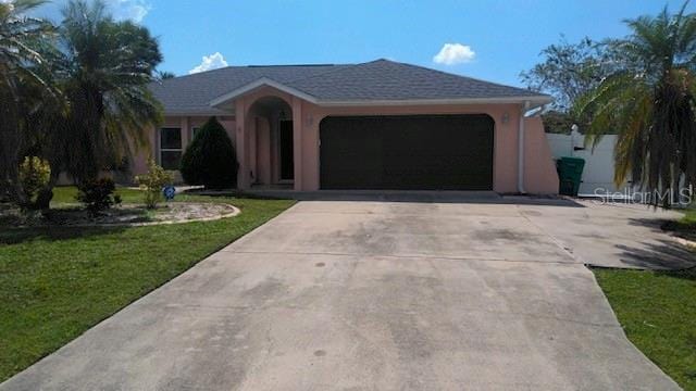 ranch-style home with a garage and a front yard