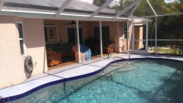 view of pool featuring a patio, a lanai, and ceiling fan