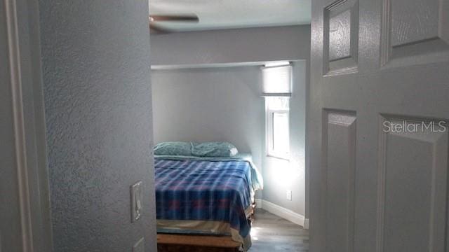 bedroom with ceiling fan and hardwood / wood-style floors