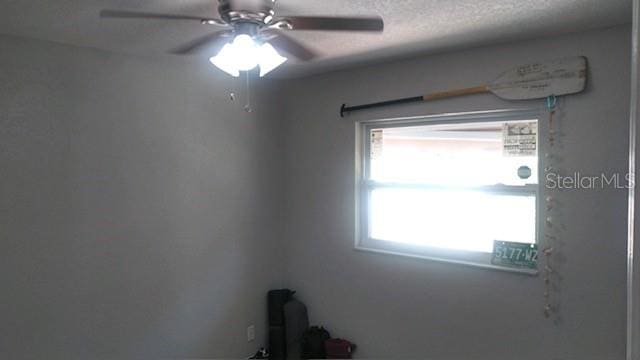 unfurnished room with ceiling fan