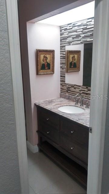 bathroom with tile patterned flooring and vanity