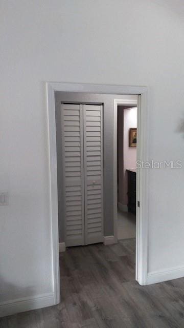 hallway with dark wood-type flooring