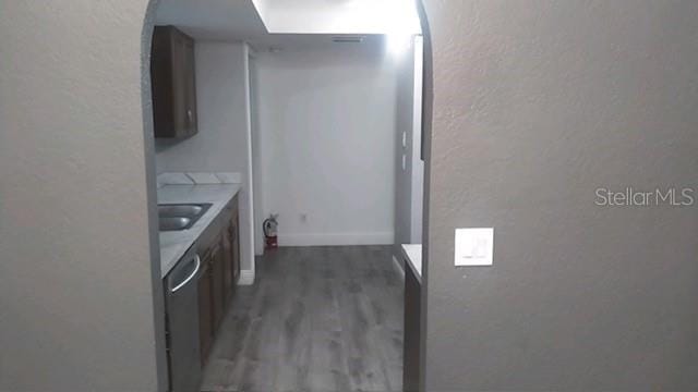 kitchen with dishwasher, dark hardwood / wood-style floors, and sink