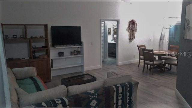 living room featuring ceiling fan and hardwood / wood-style flooring