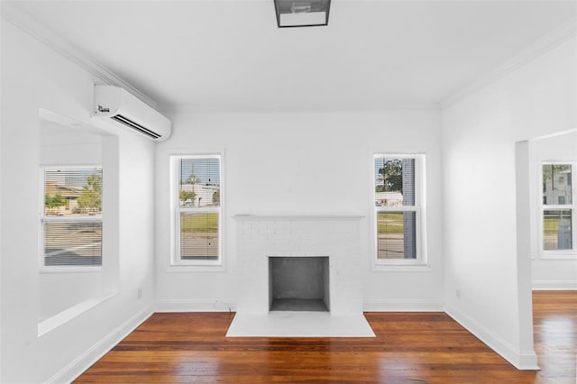 unfurnished living room featuring an AC wall unit, a brick fireplace, dark wood-type flooring, and a healthy amount of sunlight