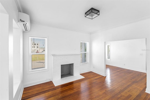 unfurnished living room with a brick fireplace, crown molding, dark hardwood / wood-style flooring, and an AC wall unit