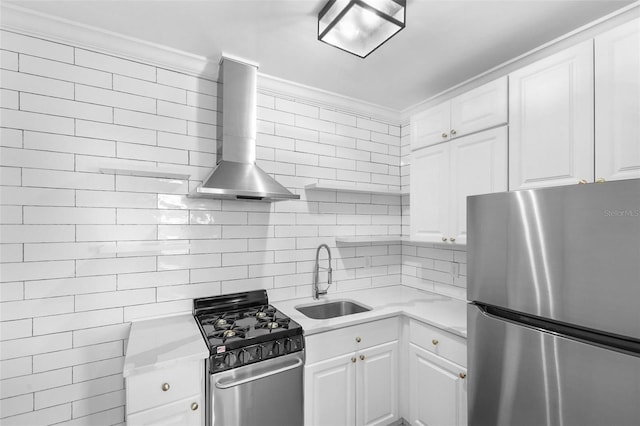 kitchen featuring stainless steel appliances, wall chimney exhaust hood, sink, and white cabinetry