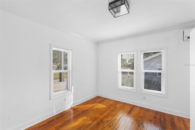 unfurnished room with a healthy amount of sunlight, ornamental molding, and wood-type flooring