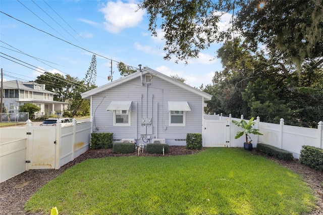 rear view of property with a yard