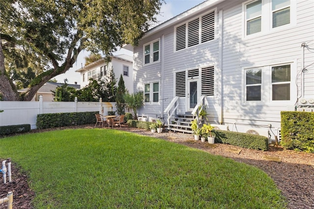 back of house featuring a yard