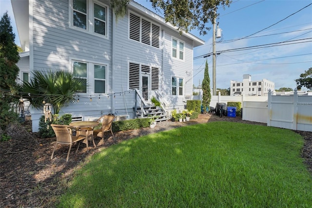 back of house featuring a lawn