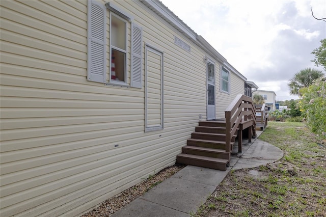 view of property exterior featuring a wooden deck