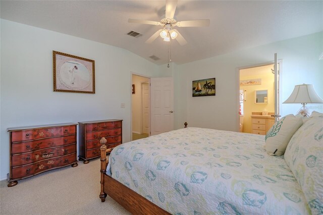 carpeted bedroom with ceiling fan, ensuite bath, and vaulted ceiling