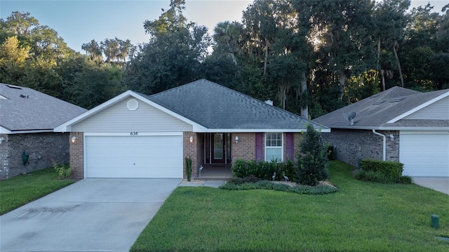 ranch-style house with a garage and a front lawn