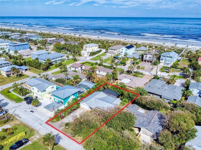 aerial view with a water view and a beach view