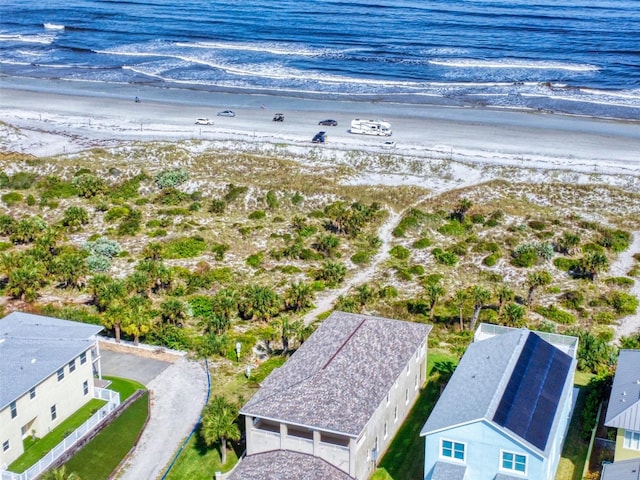 drone / aerial view featuring a water view and a beach view