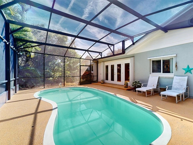 view of pool featuring a patio, french doors, and glass enclosure