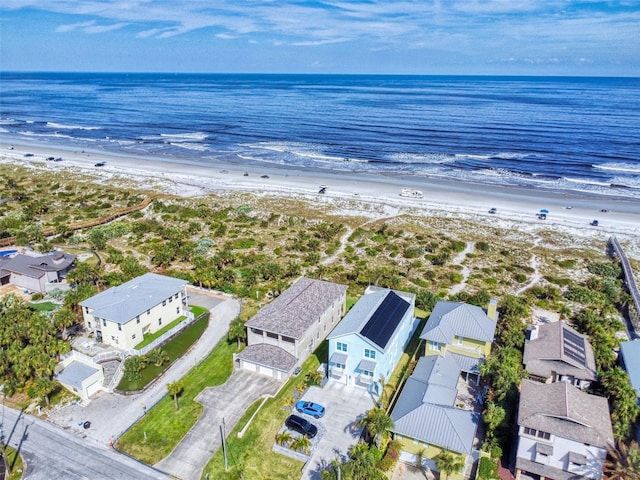 bird's eye view featuring a water view and a beach view