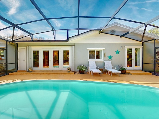 back of property featuring french doors, a patio area, and glass enclosure