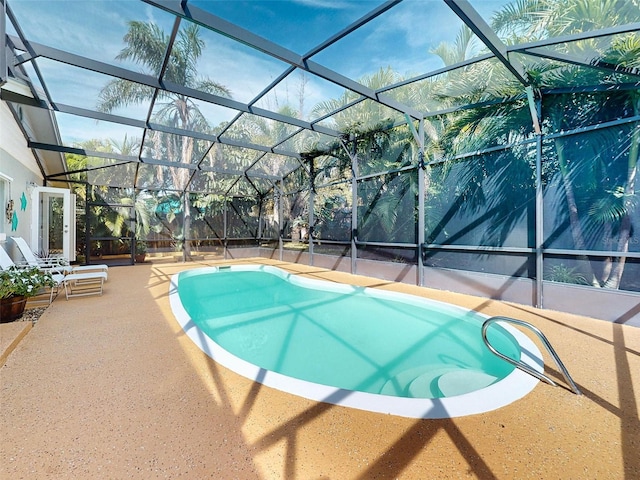 view of pool with a patio and a lanai