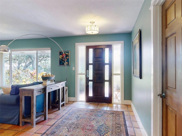 tiled foyer entrance with a textured ceiling