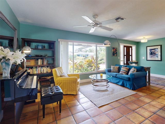 living room featuring tile patterned flooring and ceiling fan