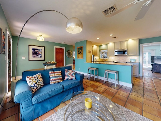 tiled living room featuring ceiling fan