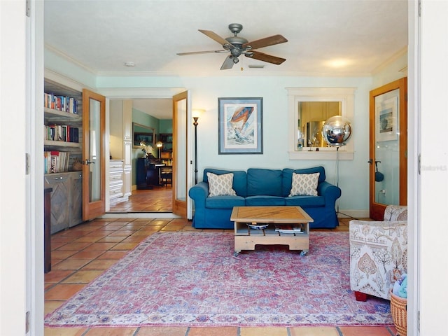 tiled living room with ceiling fan and crown molding