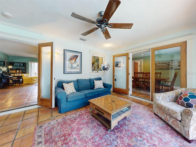 living room featuring ornamental molding, tile patterned floors, and ceiling fan