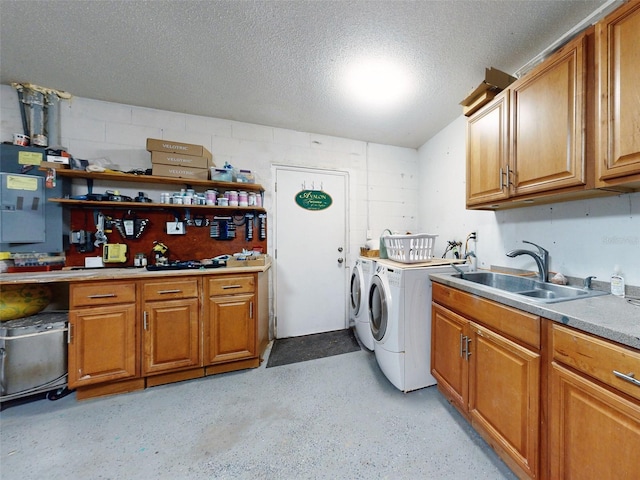 washroom featuring sink, washer and dryer, and a textured ceiling